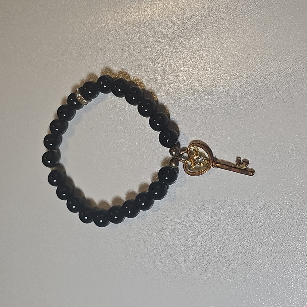 Black Onyx Beaded Bracelet with Gold Key Charm.
